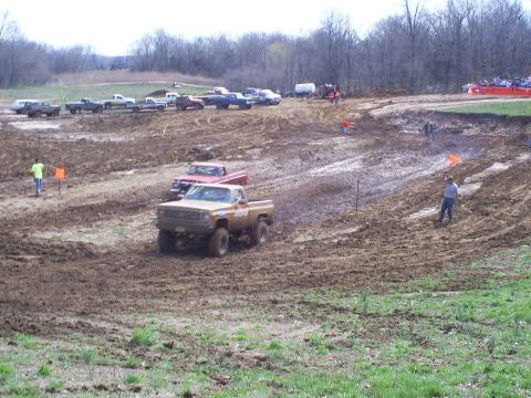 2001 Dodge 1500 - Trucks navigate a muddy off-road course during a race event.