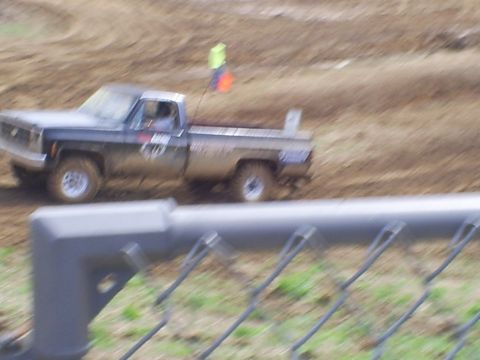 2001 Dodge 1500 - Pickup truck navigates a muddy track during an event.