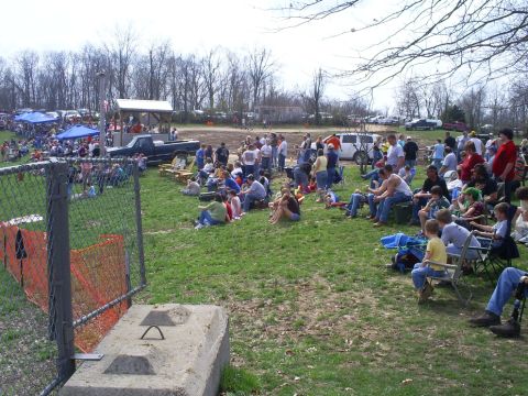 2001 Dodge 1500 - Spectators gather outdoors for an event, with several vehicles and tents visible in the distance.