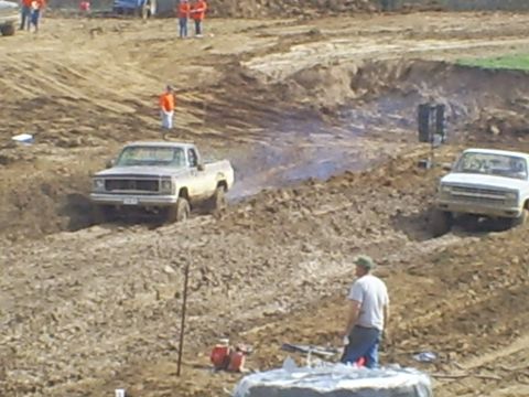 2001 Dodge 1500 - Pickup trucks compete in a mud race event on a challenging off-road course.