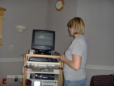 1978 Ford Bronco - A woman observes a computer screen, with a clock visible on the wall above.