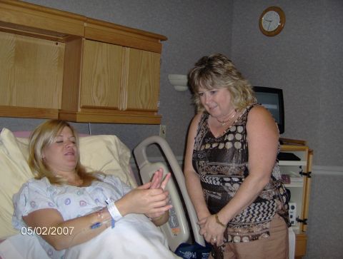 1978 Ford Bronco - A woman lies in a hospital bed while another woman stands nearby, with a clock on the wall indicating the time.