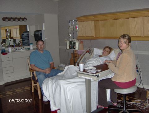 1978 Ford Bronco - A hospital room scene with three people present, including a patient in bed.
