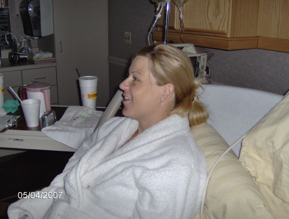 Woman in hospital gown smiles, date stamp 05/04/2007