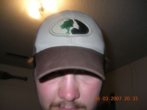 1991 Ford F-150 - A person is shown wearing a baseball cap with a logo on the front.