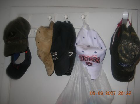 1991 Ford F-150 - A collection of hats hangs on hooks, with one displaying 'AUBURN TIGERS'.