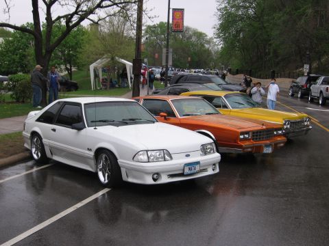 1998 GMC Sierra 1500 - Several cars are parked in a lot on a wet day, with a white coupe in the foreground.