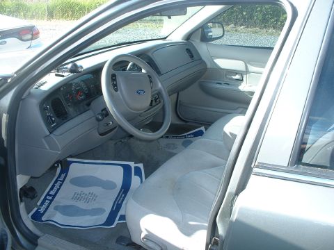 2000 Ford Crown Victoria - The interior of a 2000 Ford Crown Victoria shows light gray upholstery and dashboard details.