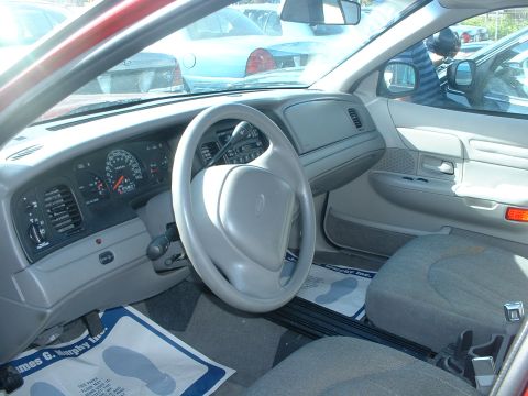 2000 Ford Crown Victoria - Interior view of a 2000 Ford Crown Victoria, showing the dashboard, steering wheel, and passenger seat.