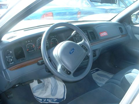 2000 Ford Crown Victoria - Interior view of a 2000 Ford Crown Victoria, showing the dashboard, steering wheel, and driver's side seat.