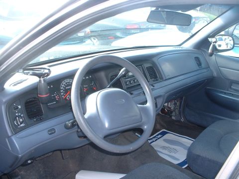 2000 Ford Crown Victoria - Interior view of a 2000 Ford Crown Victoria, highlighting the dashboard and driver's seat.