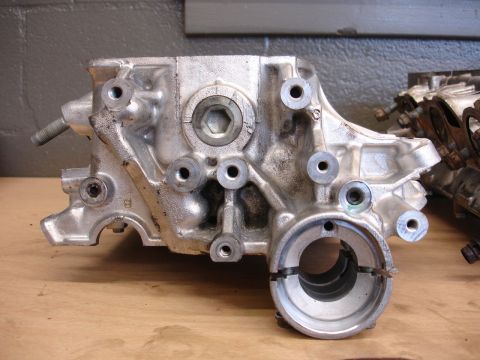 1993 Ford Taurus - This is a metallic engine component, likely a cylinder head or block section, with multiple bolt holes.
