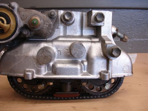 1993 Ford Taurus - A detailed view of an engine's timing chain and gear mechanism, showing mechanical components.