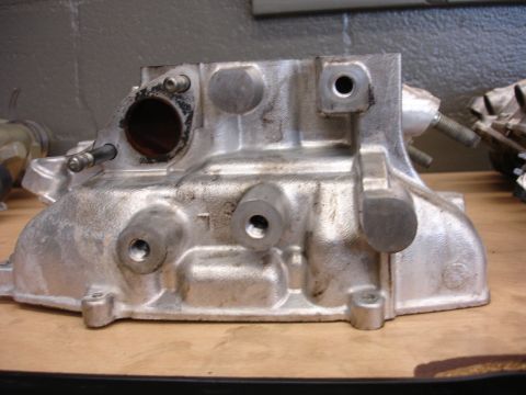 1993 Ford Taurus - Close-up view of a metallic engine component, likely a manifold or cylinder head, showing signs of use and wear.