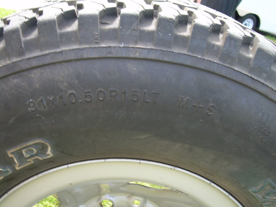 Tire with size 31x10.50R15LT M+S and part of the word GOODYEAR visible
