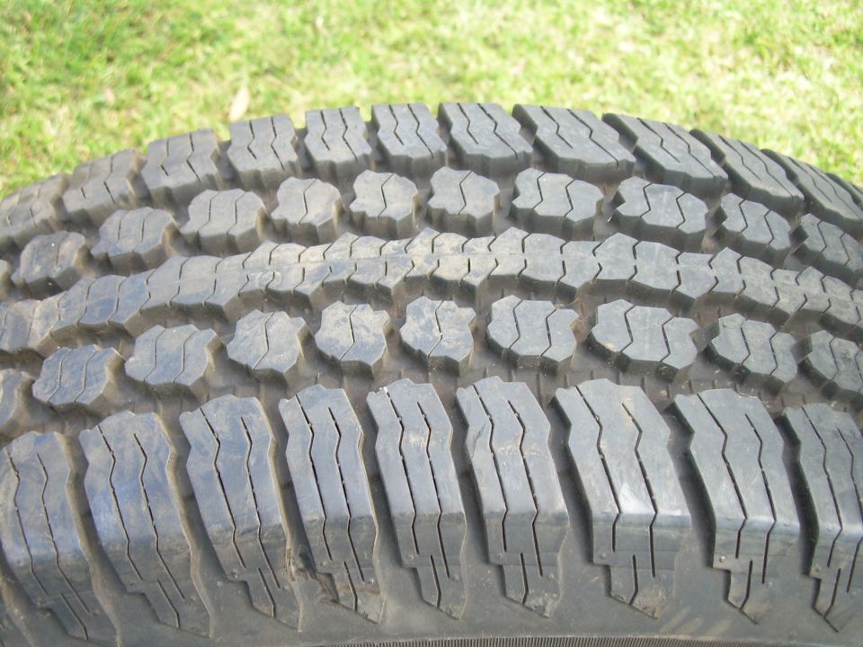 Close-up of a tire tread pattern with large, blocky lugs