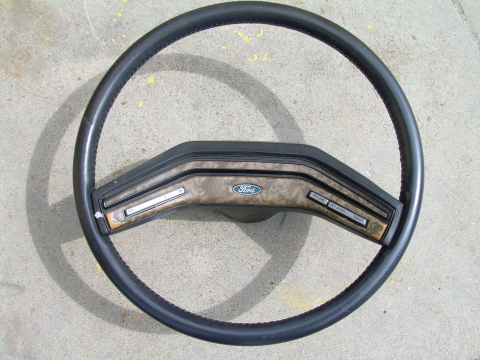 Ford steering wheel with wood grain trim and cruise control buttons