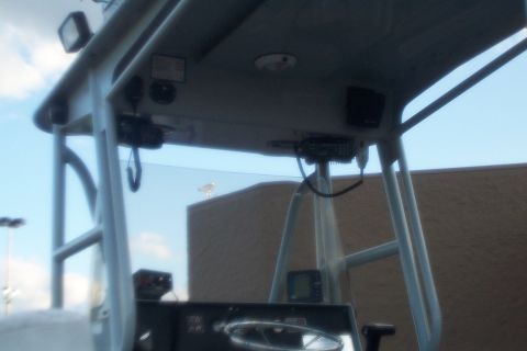 1998 Ford Crown Victoria - The interior of a boat shows the steering wheel and various electronic devices mounted on the console.