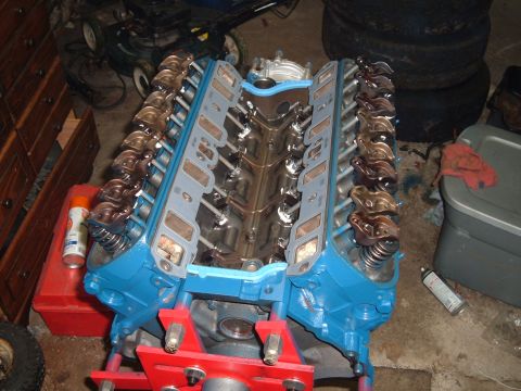1990 Ford Ranger - A blue V8 engine block is on a stand, partially assembled with gaskets and valve train components visible.