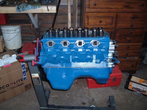 1990 Ford Ranger - A blue V8 engine is mounted on an engine stand in a workshop setting.