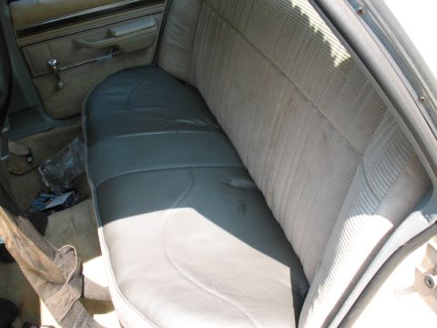 1985 Ford Crown Victoria LTD - The interior view shows the rear seat and door panel of a vehicle.
