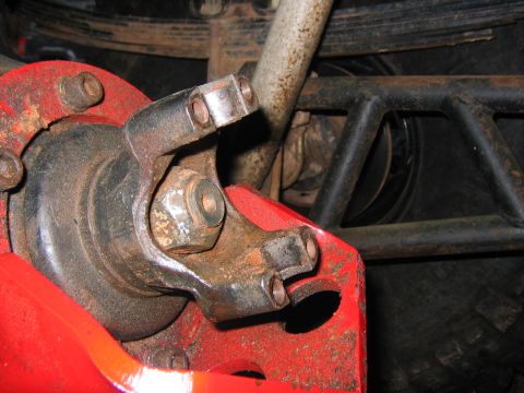 1979 Ford Bronco - Detail of a vehicle's drivetrain and suspension components, showing a u-joint and surrounding hardware.