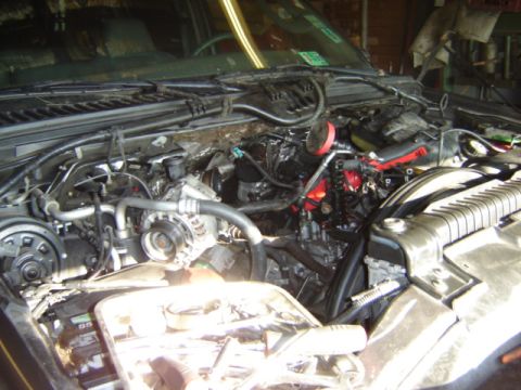 1992 Ford Bronco - The engine bay of a truck is shown with some components removed for maintenance.