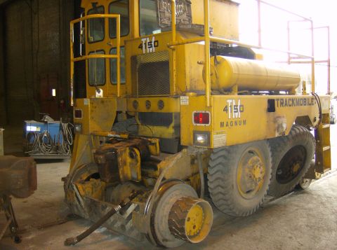 1996 Ford Probe - A yellow Trackmobile vehicle, model 4150 Magnum, is shown from the rear in an indoor setting.