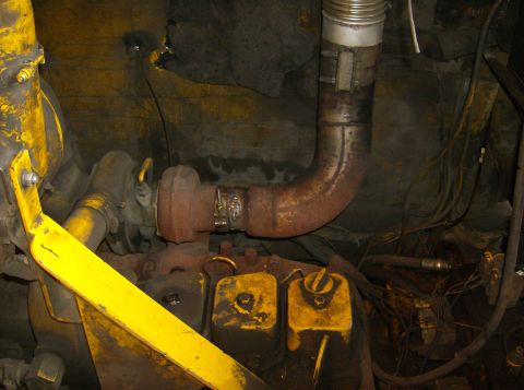 1996 Ford Probe - Close-up view of an engine component, likely a turbocharger and exhaust system, with yellow painted parts.