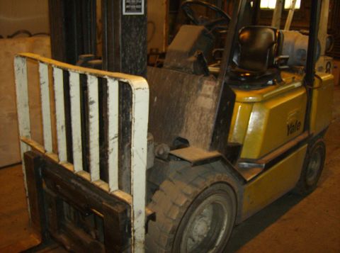 1996 Ford Probe - A yellow Yale forklift is shown from the front-right angle, with its forks and mast in view.