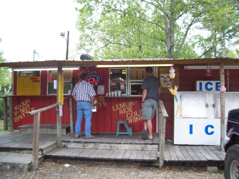 1992 Ford Bronco - A red food stand with a wooden deck serves customers on a sunny day.