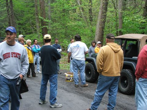 1996 Ford Bronco - A group of people gather around a Jeep Wrangler during an outdoor event.