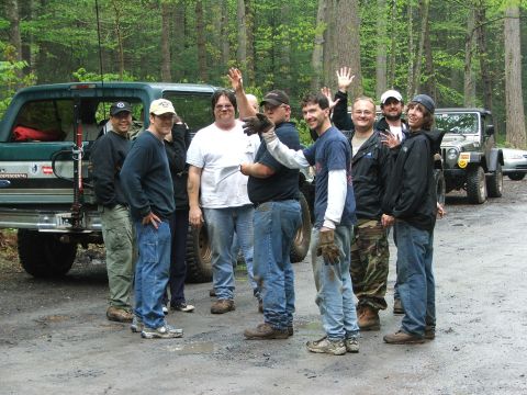 1996 Ford Bronco - A group of people stand around a green Ford Bronco and a Jeep in a wooded area.