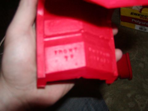 1991 Ford Bronco - Red plastic part with molded text indicating orientation.