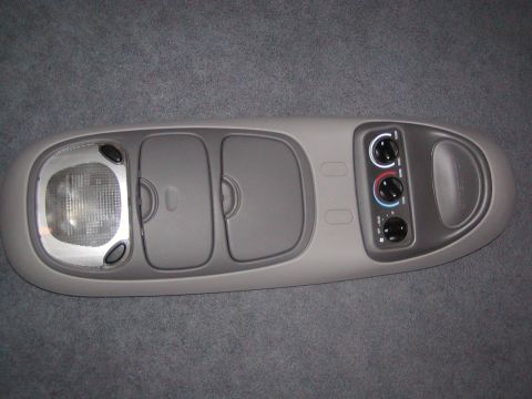 1991 Ford Bronco - This overhead console features a dome light, storage bins, and climate controls with temperature and fan speed settings.