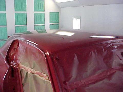 1967 Mercury Cougar - A red car is being prepped for painting inside a booth with green sound-dampening panels on the wall.