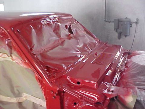 1967 Mercury Cougar - Car body in a paint booth, covered in protective sheeting during a paint job.
