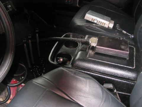 1991 Ford Bronco - Aftermarket electronics and multiple gear shifters are visible in the interior of this vehicle.