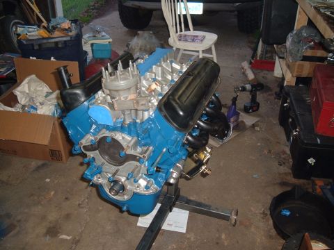 1990 Ford Ranger - A rebuilt V8 engine, painted blue, is mounted on an engine stand in a garage setting.