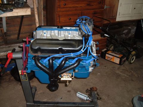 1990 Ford Ranger - Engine on a stand, likely a V8, with blue paint and black exhaust headers.