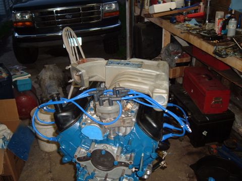 1990 Ford Ranger - V8 engine assembly with intake manifold and spark plug wires, in a garage setting.