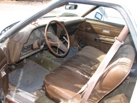 1973 Ford Ranchero - Interior view of a 1973 Ford Ranchero, brown vinyl seats and a wooden steering wheel.
