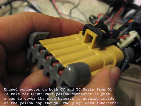2001 Ford Crown Victoria - Unused connector on 2001 CV and TC seats, possibly for OCSM, with a yellow cap covering the plug.