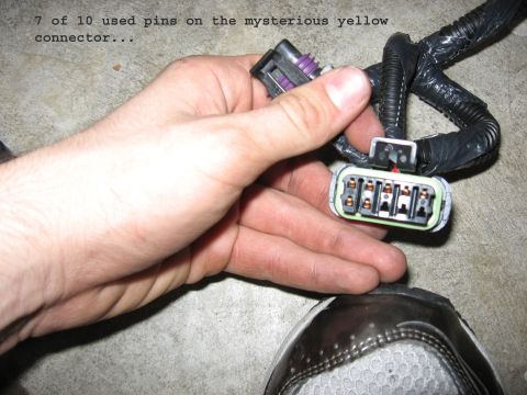 2001 Ford Crown Victoria - Close-up of a hand holding electrical connectors and wiring. Text indicates 7 of 10 pins are used.