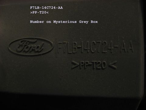2001 Ford Crown Victoria - Embossed Ford logo and part number F7LB-14C724-AA on a grey plastic component.