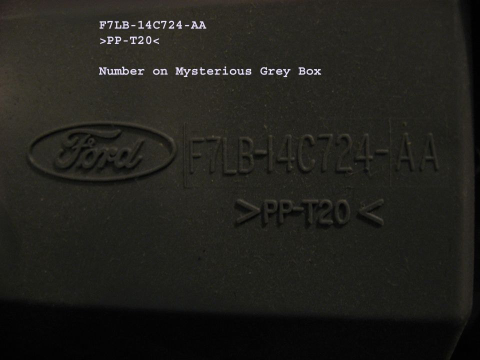 Ford logo and part number F7LB-14C724-AA embossed on a grey plastic part