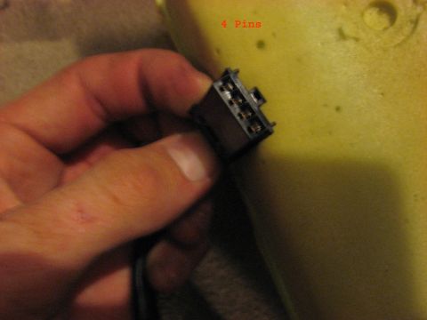 2001 Ford Crown Victoria - A hand holds a four-pin electrical connector, with text indicating the pin count.