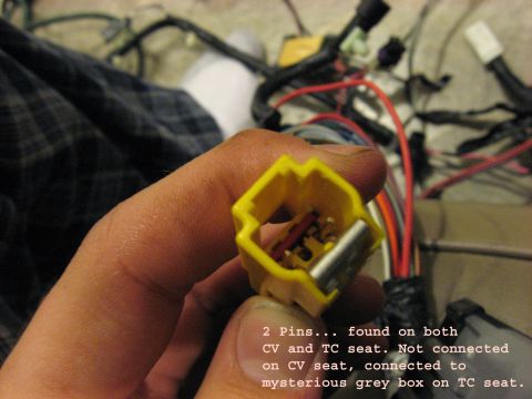 2001 Ford Crown Victoria - A yellow electrical connector with two pins is held in a hand, with wiring visible in the background.