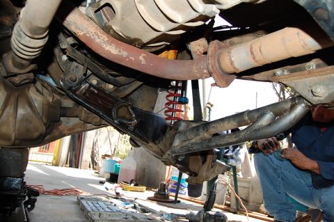 1992 Ford Explorer - Close-up of vehicle undercarriage components, including exhaust pipes and suspension parts.