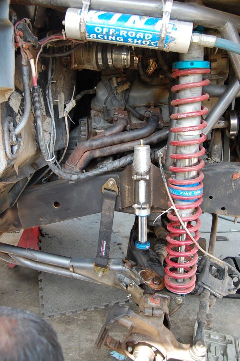 1992 Ford Explorer - Close-up view of off-road racing shock absorbers and suspension parts, with visible text on the shock body.